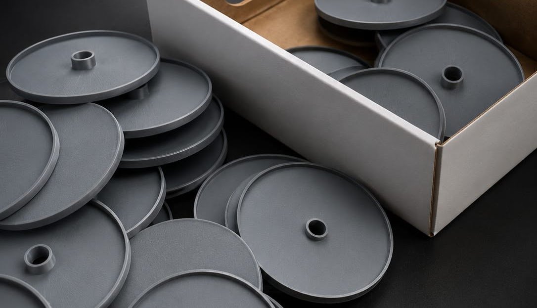 Batch of grey 3D-printed disc parts ready for delivery